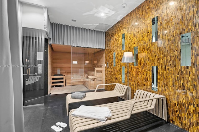 tiled bedroom featuring wooden walls