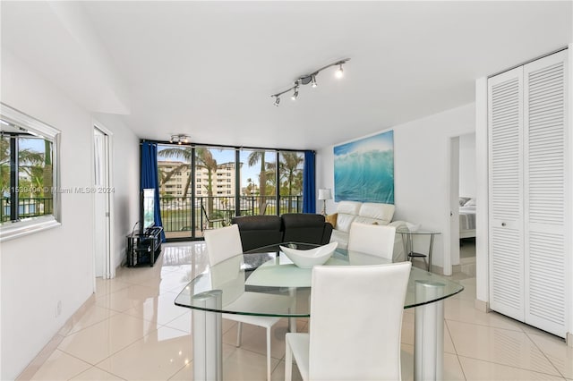 dining area featuring light tile floors and track lighting