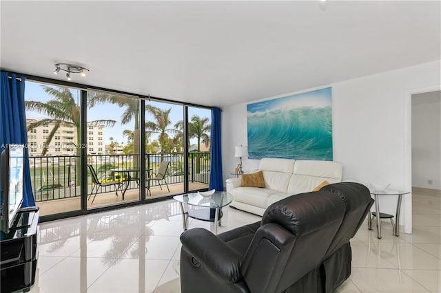 living room with a wall of windows and light tile floors