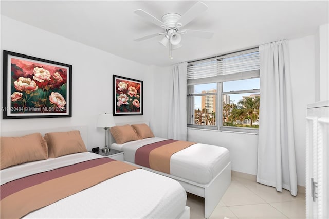 tiled bedroom featuring ceiling fan