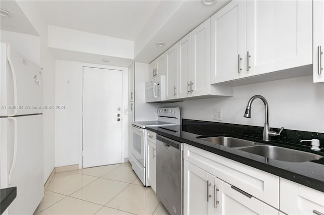 kitchen with white appliances, white cabinets, sink, and light tile floors