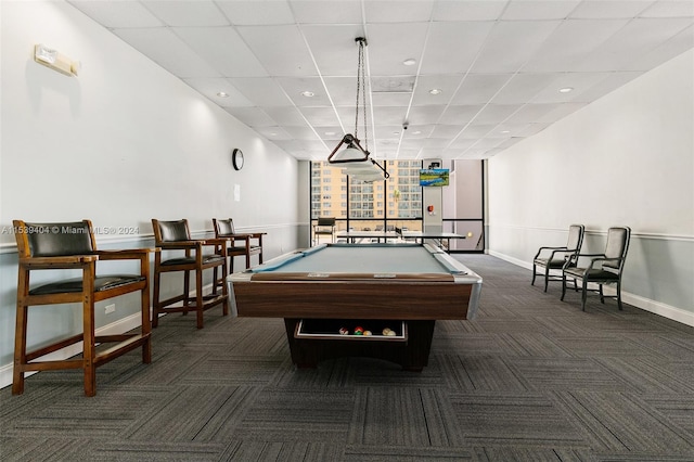 rec room with dark carpet, pool table, and a drop ceiling