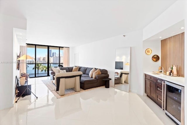 tiled living room with beverage cooler, expansive windows, and a water view