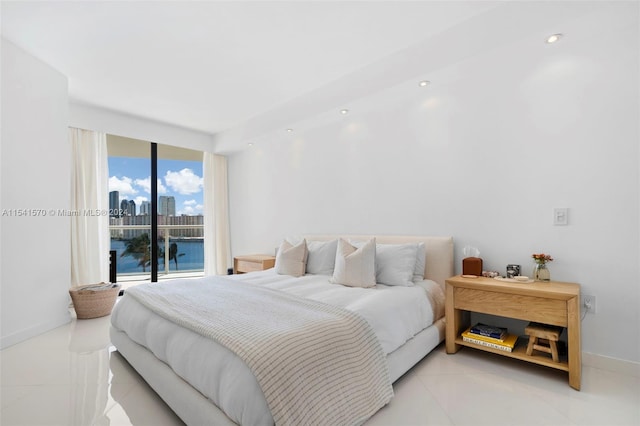 tiled bedroom with a water view