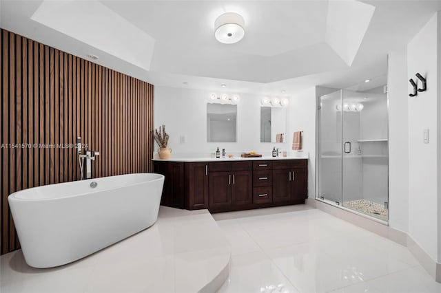 bathroom featuring double sink, tile flooring, independent shower and bath, and vanity with extensive cabinet space