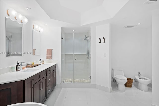 bathroom with dual vanity, tile floors, toilet, a bidet, and a shower with shower door