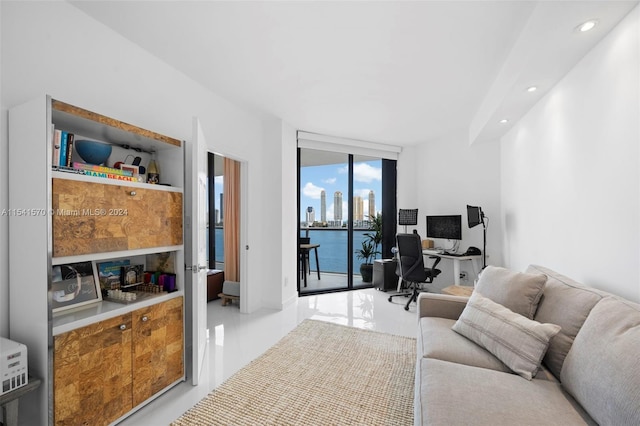 living room with a wall of windows and a water view