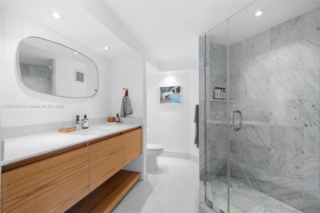 bathroom with vanity, tile flooring, toilet, and walk in shower