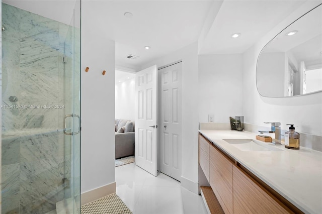 bathroom with oversized vanity, an enclosed shower, and tile flooring