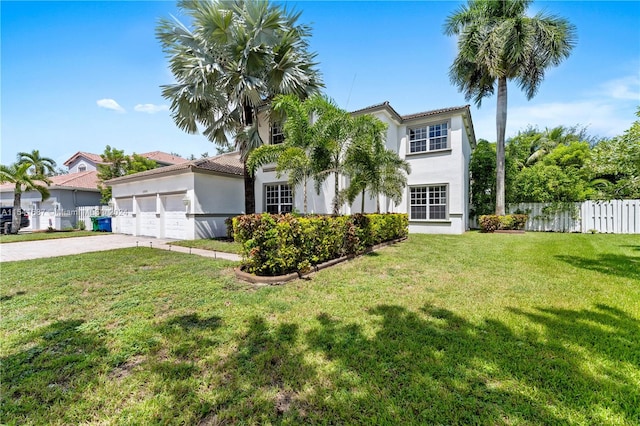 view of front of house with a front yard and a garage