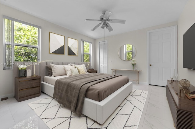 bedroom with light tile flooring, multiple windows, a closet, and ceiling fan