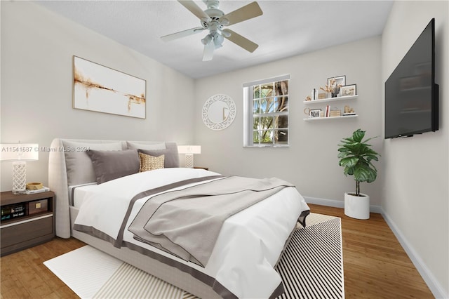 bedroom with ceiling fan and dark hardwood / wood-style flooring