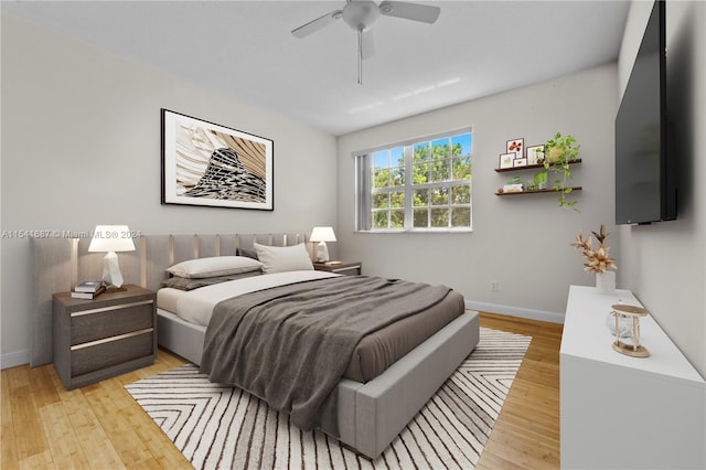 bedroom with ceiling fan and light wood-type flooring