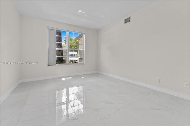 spare room featuring light tile floors