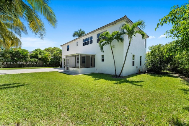 back of house with a lawn