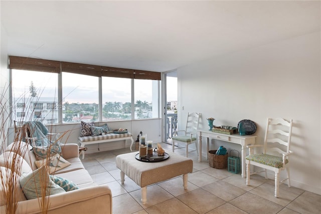 living room with light tile floors and a wall of windows