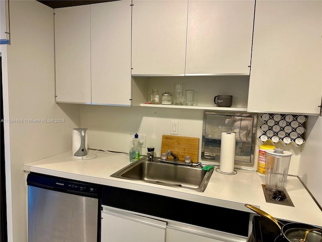 kitchen featuring white cabinets, stainless steel dishwasher, and sink