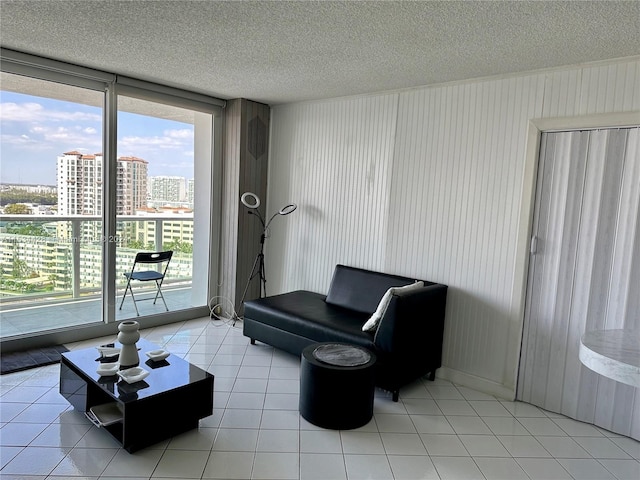 living area with light tile floors and a textured ceiling