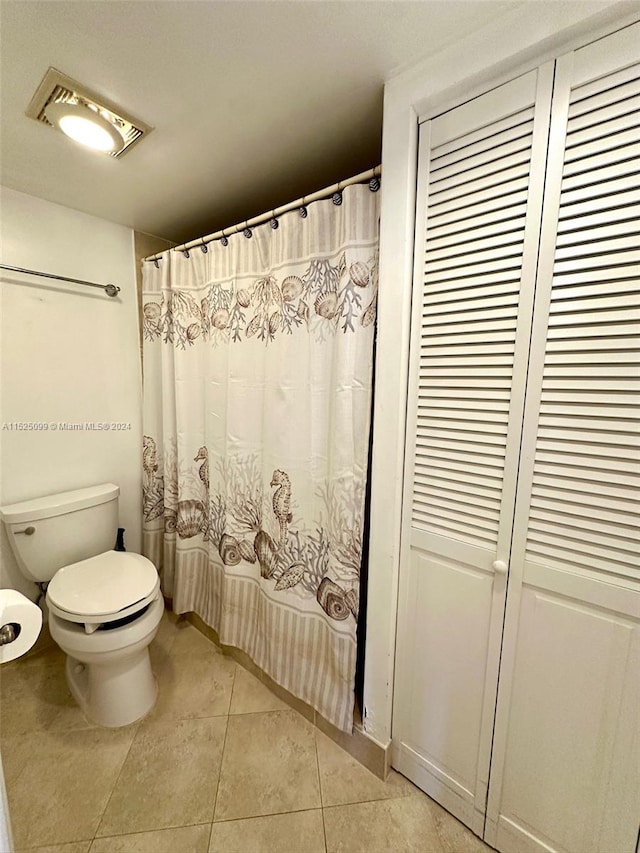 bathroom with tile floors and toilet