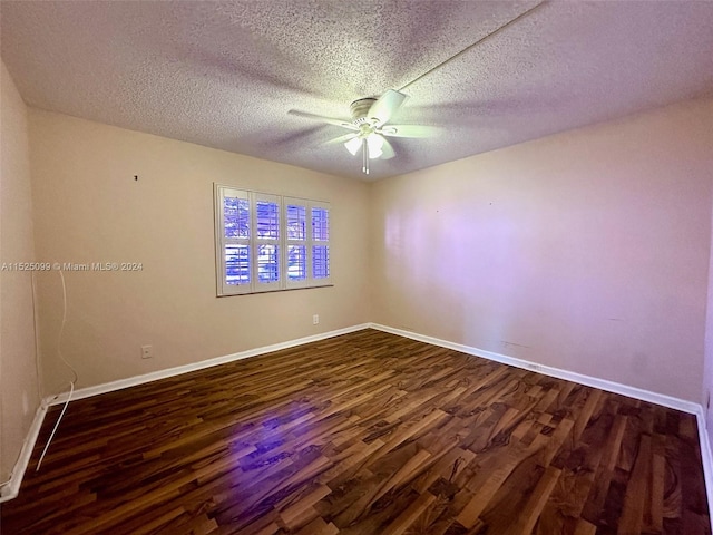 unfurnished room with dark wood-type flooring, ceiling fan, and a textured ceiling