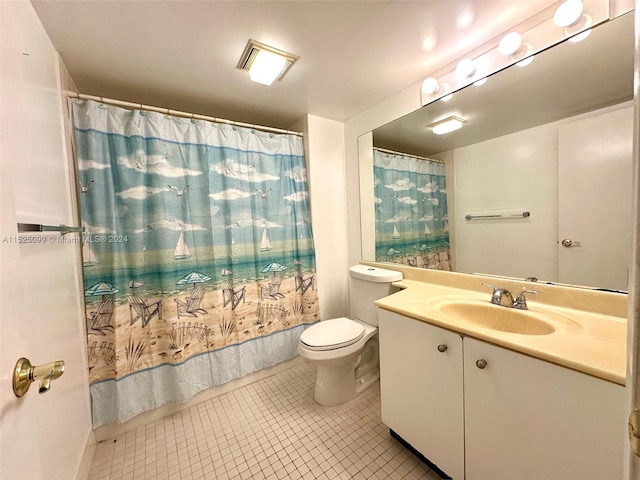 bathroom featuring tile floors, large vanity, and toilet