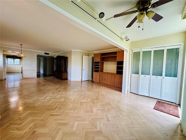 spare room featuring crown molding, light parquet floors, and ceiling fan