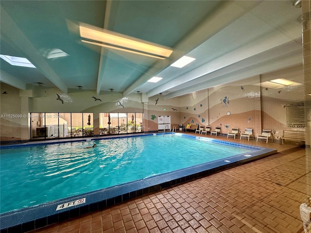 view of pool featuring a skylight