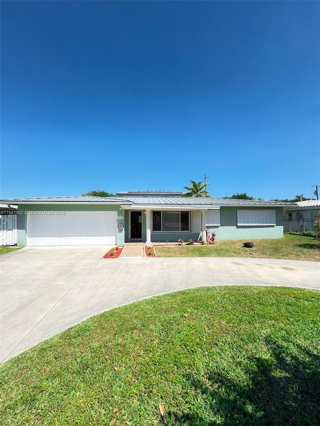 ranch-style home with a garage, a front lawn, concrete driveway, and fence