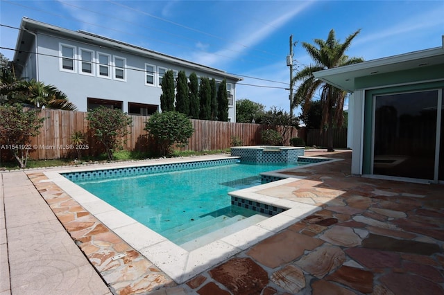 view of pool with an in ground hot tub and a patio