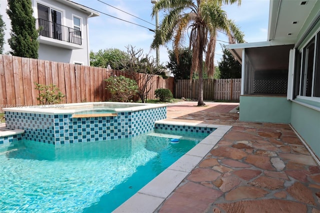 view of pool featuring a patio, a fenced in pool, a fenced backyard, and an in ground hot tub