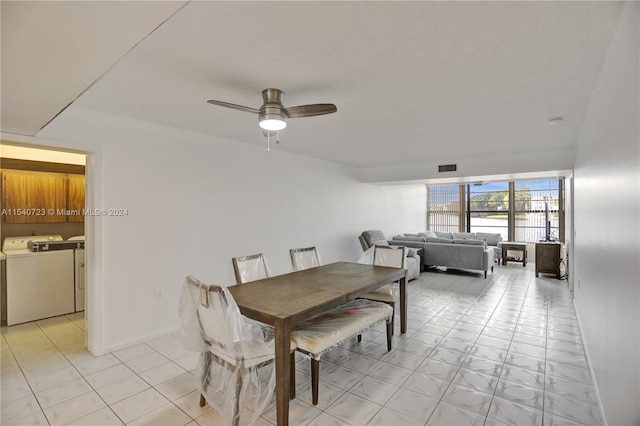 tiled dining space featuring separate washer and dryer and ceiling fan