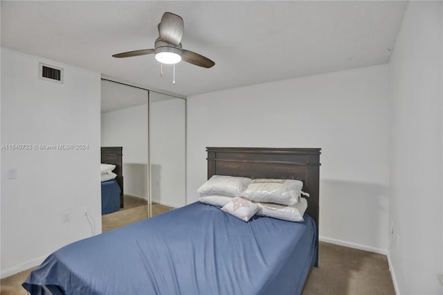 carpeted bedroom with ceiling fan and a closet