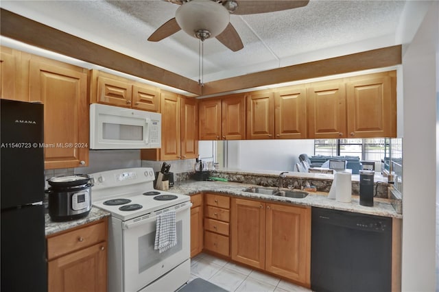 kitchen featuring light tile patterned flooring, ceiling fan, black appliances, light stone countertops, and sink