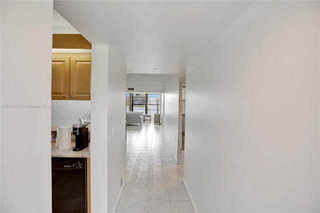 corridor featuring light tile patterned floors