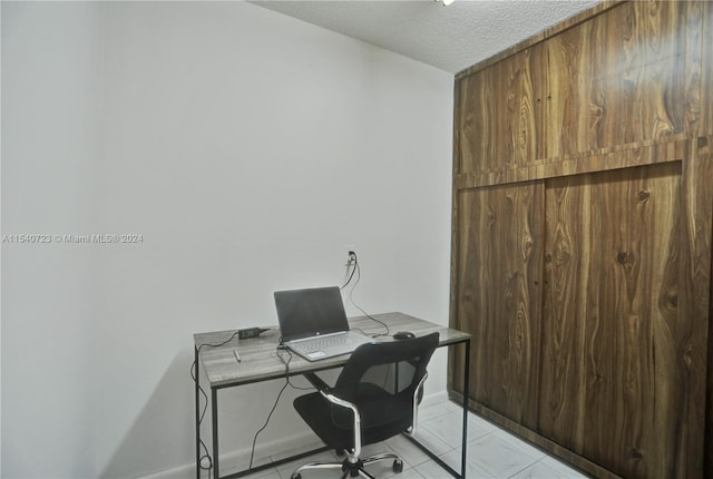 tiled office with a textured ceiling