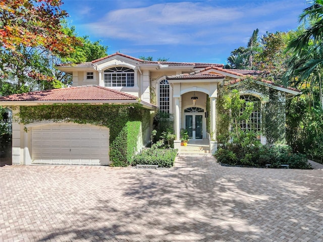 mediterranean / spanish home featuring a garage