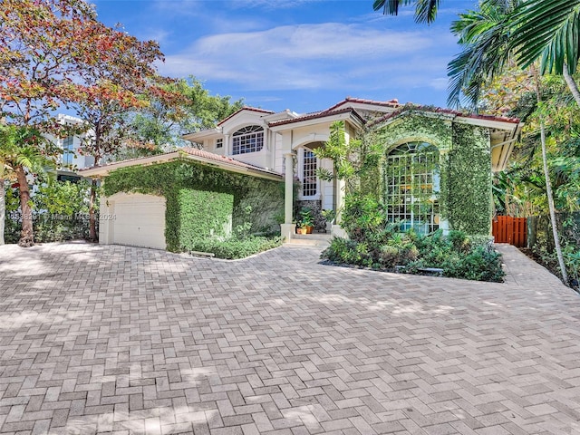 mediterranean / spanish-style home featuring a garage