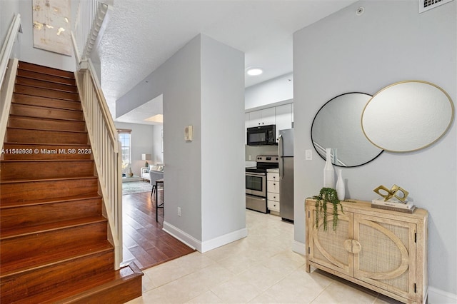 interior space with light hardwood / wood-style flooring and a textured ceiling