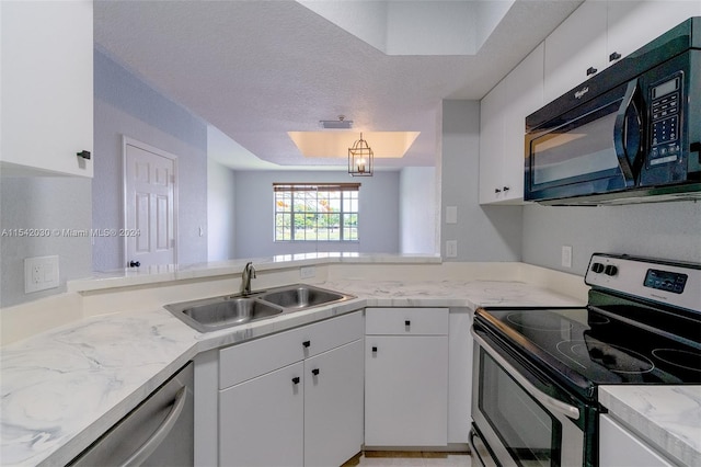 kitchen featuring white cabinets, sink, stainless steel appliances, and a textured ceiling