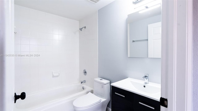 full bathroom with toilet, vanity, and tiled shower / bath