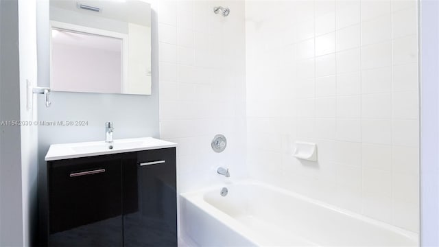 bathroom featuring vanity and tiled shower / bath combo