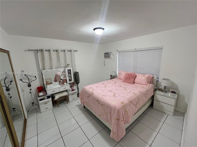 bedroom featuring a wall mounted air conditioner and light tile floors