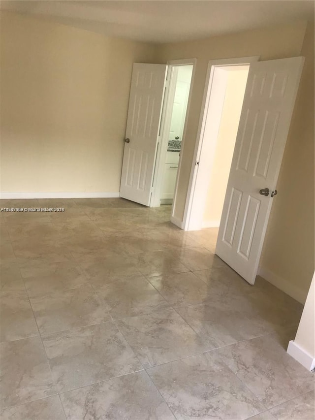 unfurnished room featuring light tile floors