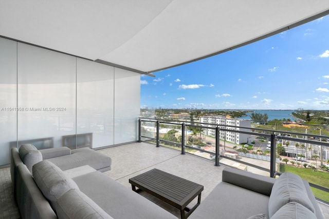 balcony with outdoor lounge area and a water view