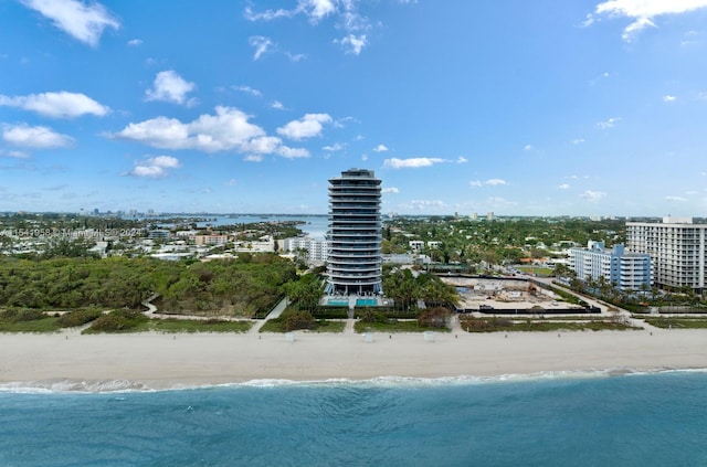 birds eye view of property with a water view and a view of the beach