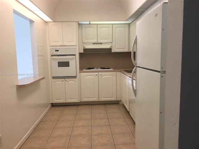 kitchen with light tile floors, white appliances, and white cabinetry