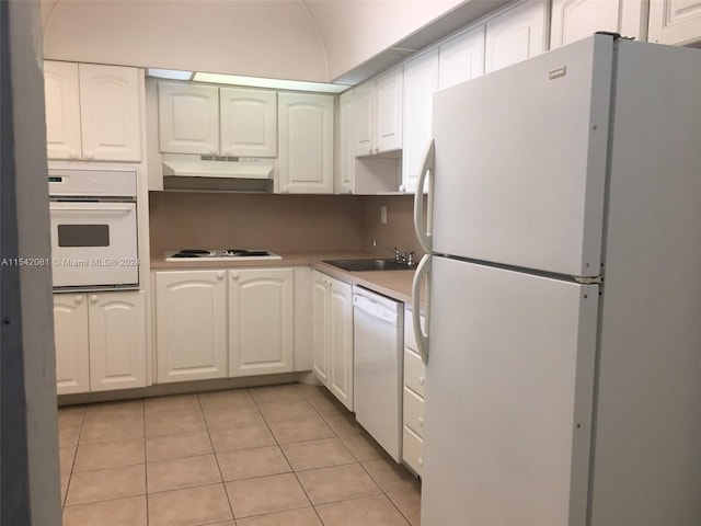 kitchen featuring white appliances, sink, white cabinetry, and light tile floors