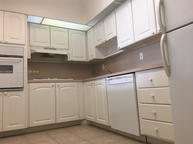 kitchen featuring white appliances, white cabinets, and light tile floors