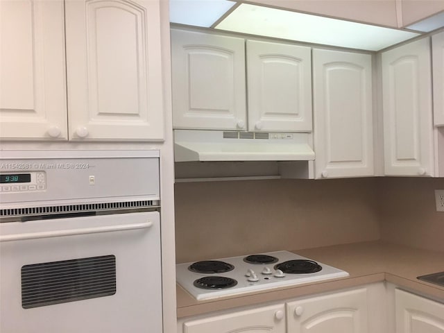 kitchen featuring white appliances and white cabinetry