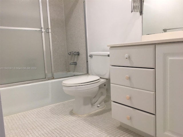 full bathroom with toilet, combined bath / shower with glass door, tile floors, and vanity